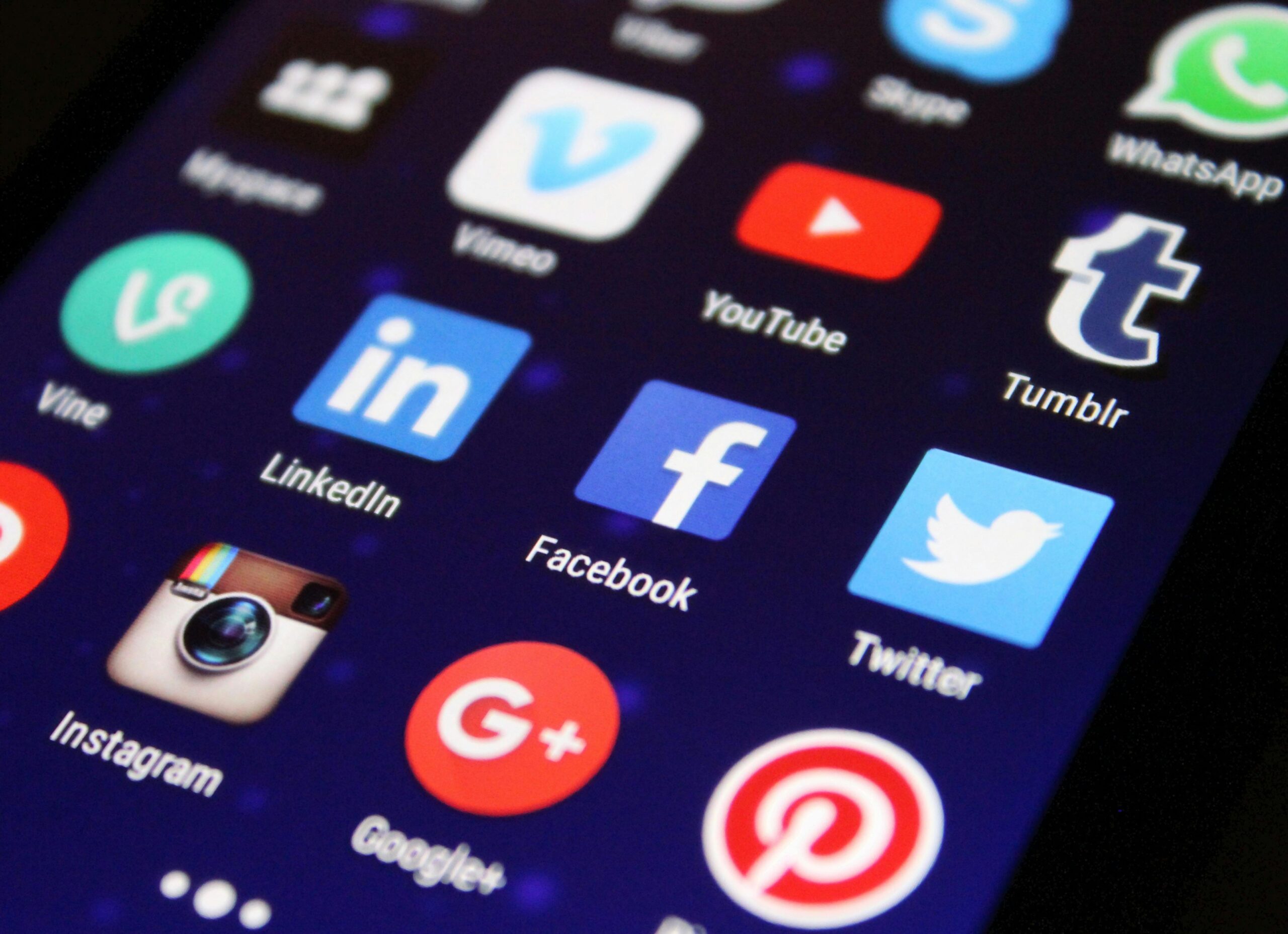 Offerings Close-up of a smartphone screen showing various social media app icons such as Facebook and Twitter.